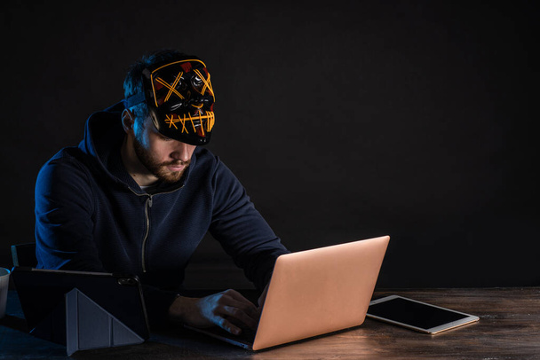 young hacker male use laptop to gain unauthorized access to data - Fotó, kép