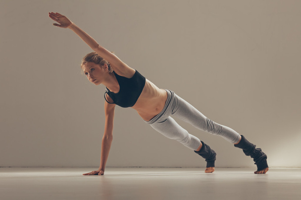 Young Woman Doing Yoga Indoors - Фото, изображение