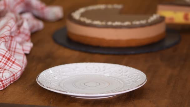 Piece of Chocolate Cherry Mousse Cake on a plate. - Felvétel, videó