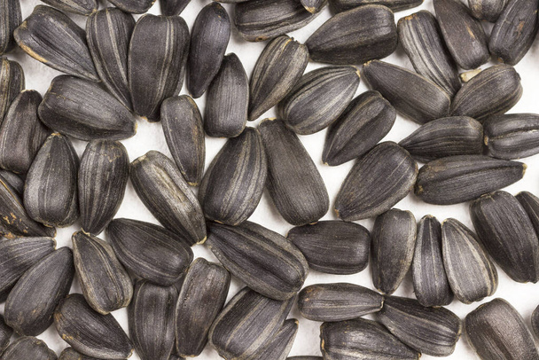 Unpeeled sunflower seeds. Source of iodine and calcium. natural source of iodine and calcium. Healthy eating concept. Natural background. Top view - Photo, Image
