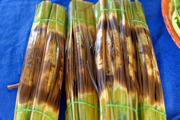 Sticky rice on banana leaf is a traditional thai street food sweet snack - 写真・画像