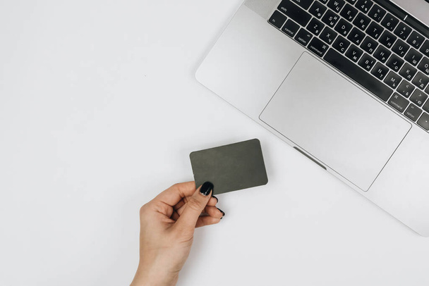 Hands holding credit card and using laptop. Online shopping  - Foto, Imagem