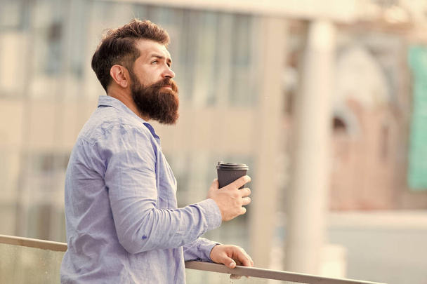 Bearded man relax. brutal hipster with coffee cup. energy charge. Male barber care. copy space. Time zone. thoughtful man drink take away coffee outdoor. morning coffee. Mature hipster with beard - Foto, imagen