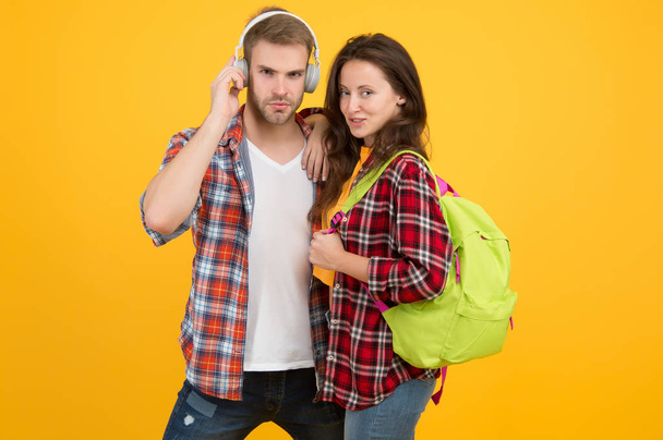 Modern couple wearing matching outfits. Family look concept. Shopping day. Trendsetters. Youth lead way in fashion ideas. Hipster couple students. Fashionable students couple yellow background - Фото, изображение