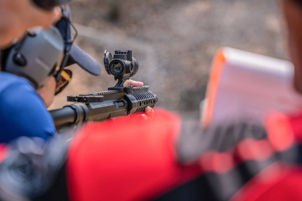 selective focus of man holding and fire sub machine gun in gun shooting competition - Fotoğraf, Görsel