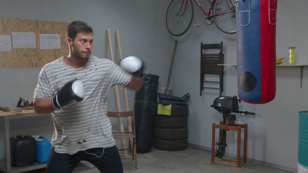 Athlete is practicing punches on a punching bag  - Photo, Image
