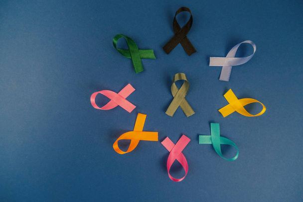Close up of cancer ribbons on  royal blue background. Cancer awareness month.  - Photo, Image