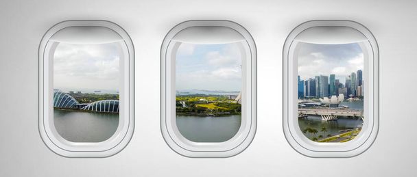 Ventanas de avión con vistas al horizonte de Singapur. Concepto abstracto sobre viajes y vacaciones. - Foto, imagen