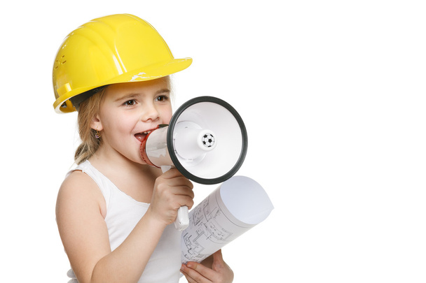Little girl builder in yellow helmet screaming into the loudspeaker - Foto, Imagem