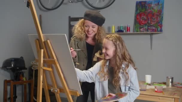 Happy girl and woman paint a picture - Video