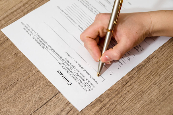 female hand signing a contract  on desk - Фото, зображення