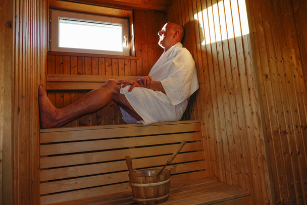 A man relaxes in a sauna - Photo, Image
