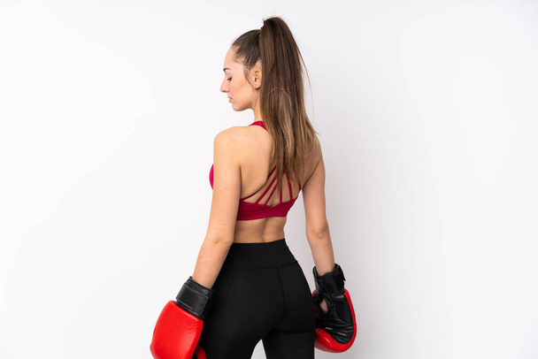 Young sport brunette woman over isolated white background with boxing gloves - Foto, Imagen