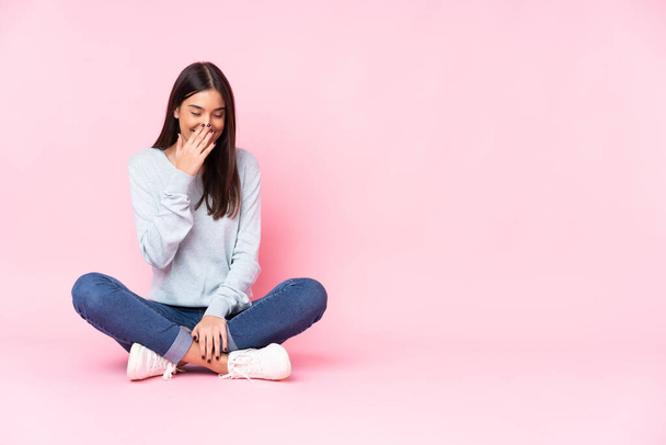 Young caucasian woman isolated on pink background smiling a lot - Photo, Image