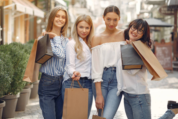 Cute girls with shopping bag in a city - Zdjęcie, obraz