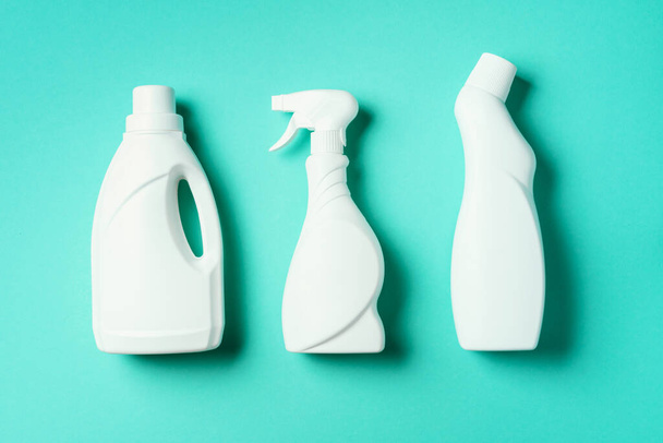 Composition with plastic bottles of cleaning products over blue background. Top view. Flat lay. Copy space. Plastic waste. Detergent bottle pattern - Foto, Imagen