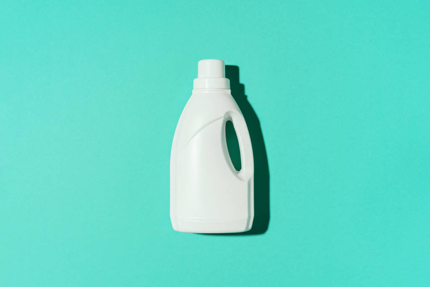 White plastic bottle of cleaning product, household chemicals or liquid laundry detergent on blue background. Top view. Flat lay. Copy space. Detergent bottle - 写真・画像