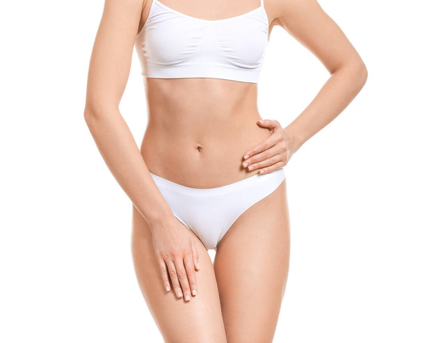 Young woman in underwear on white background. Concept of plastic surgery - 写真・画像