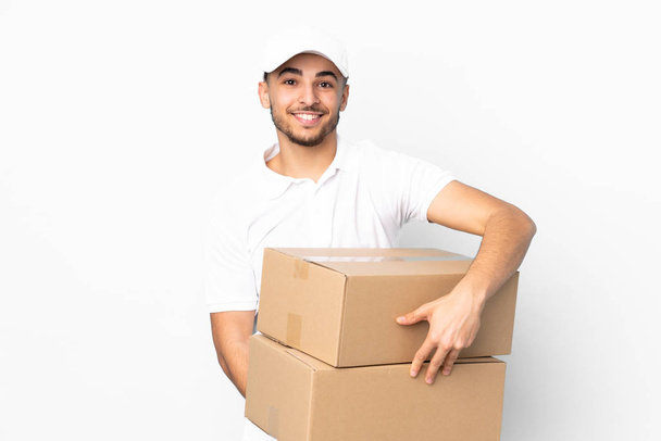 Delivery Arabian man isolated on blue background laughing - Valokuva, kuva