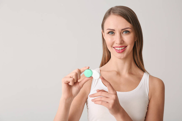 Woman with contact lenses on light background - Photo, Image