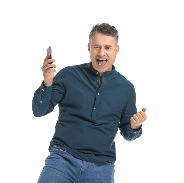 Happy mature man with mobile phone on white background - Valokuva, kuva