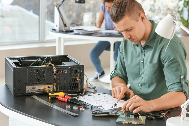 Electronic technician working in service center - Photo, Image