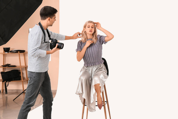 Professional photographer working with model in studio - Fotoğraf, Görsel