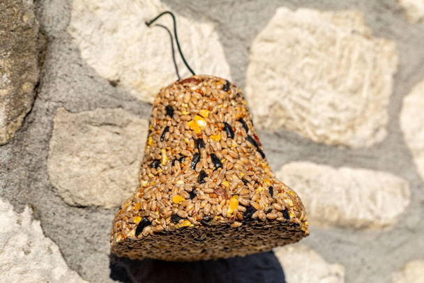 Bell from various grains, a delicacy for all the birds in the garden - Photo, Image
