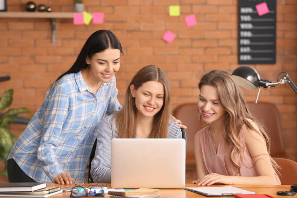 Beautiful young businesswomen working together in office - Фото, зображення