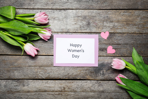 Card for International Women's Day and flowers on wooden background - Fotó, kép