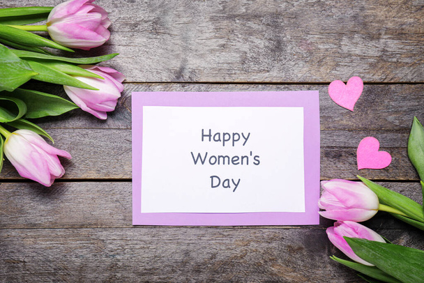 Card for International Women's Day and flowers on wooden background - Foto, imagen
