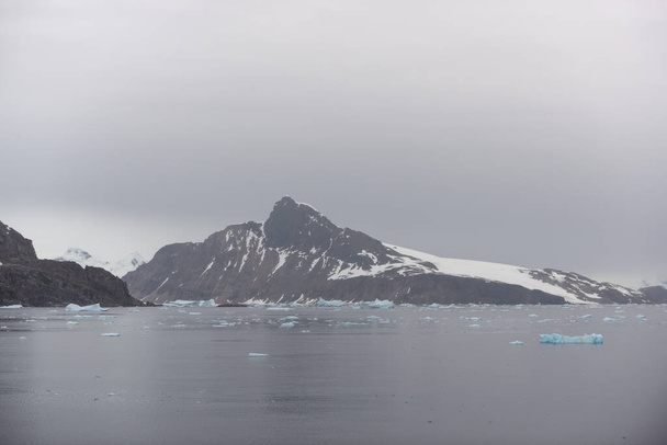 Antarctic beach with glacier and mountains, view from expedition ship - Photo, Image