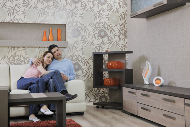 Couple relax at home on sofa in living room - Foto, Imagen