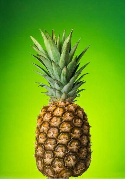 Large ripe pineapple, on green background, closeup - Fotoğraf, Görsel