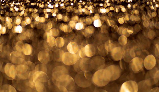 Golden glitter particles background. Sparkling light. - Photo, image