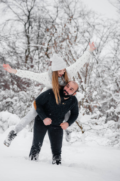 Couple playing with snow in the forest - Фото, зображення