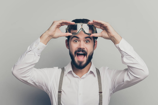 Portrait of astonished guy look unbelievable news information touch safety goggles scream wow omg wear modern outfit isolated over grey color background - Fotó, kép