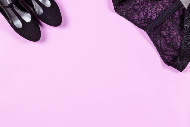 Set of fashion stylish clothes and accessories- black cocktail dress, shoes on pink background. Concept for party outfit, birthday, glamor lady. Flat lay, top view - Photo, Image