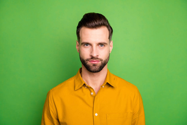 Close-up portrait of his he nice attractive calm serious guy wearing casual formal shirt modern look haircut isolated on bright vivid shine vibrant green color background - Foto, Bild