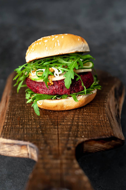 veggie burger with beets, chickpeas, pear, arugula, cucumber on a cutting board on a stone background - Zdjęcie, obraz