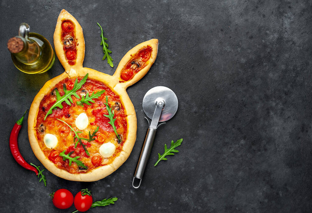 Easter pizza in the form of a hare with eggs on a stone background - Foto, afbeelding