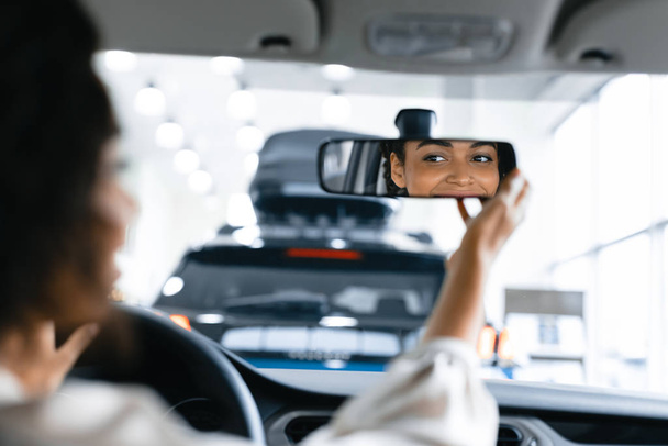 Girl Checking Mirrors Sitting In Drivers Seat In Dealership Store - Φωτογραφία, εικόνα