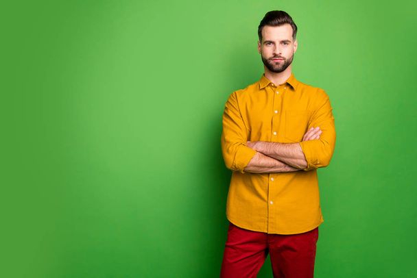 Photo of amazing young business man bossy crossed arms not satisfied colleagues late work strict chief wear yellow shirt red pants isolated green color background - Photo, Image