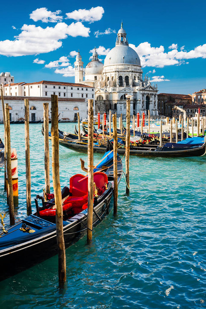 View of Grand Canal in Venice, Italy, with colorful gondola boats in the foreground - Photo, Image