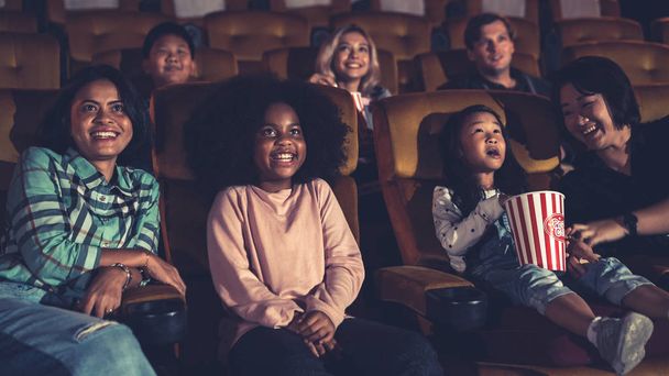 People audience watching movie in the movie theater cinema. Group recreation activity and entertainment concept. - Photo, Image
