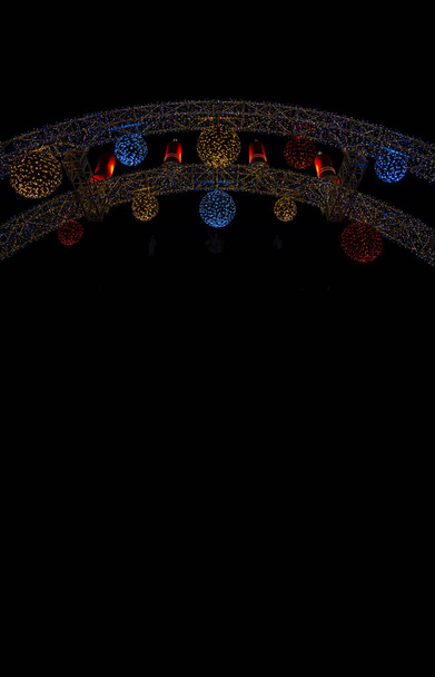 dark festive pattern poster concept colorful chandelier foreshortening from below on vertical picture with black background space for copy or your text here - Photo, Image