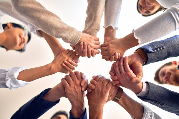 Groupe de travailleurs d'affaires debout avec les mains ensemble au bureau
 - Photo, image