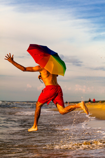 Happy man jumping on the beach - Φωτογραφία, εικόνα