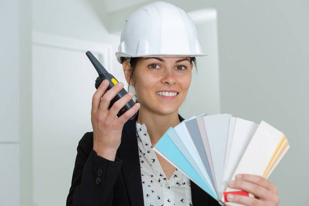female foreman holding color wheel and walkie talkie - Zdjęcie, obraz