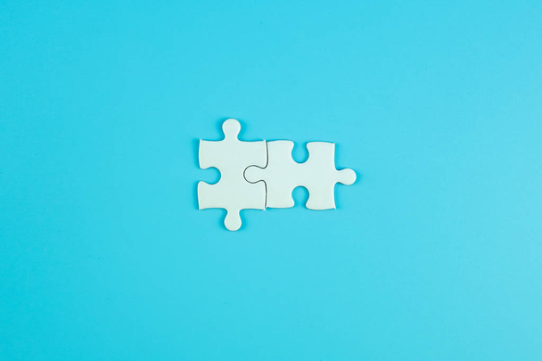 Jigsaw puzzle pieces on blue background with copy space for text. solutions, mission, successful, goals, cooperation, partnership and strategy concept - Foto, immagini